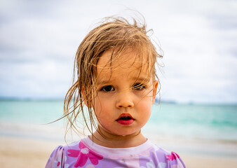 Close up portrait of beautiful young girl at beach