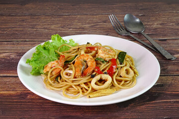 Spaghetti : Spicy seafood spaghetti, Thai style spicy and herbs spaghetti. Famous fusion Italian food in Thailand, selective focus