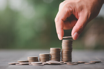 business finance and saving money investment concept, Hand with Money coin stack growing graph...