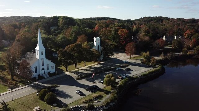 Aerial view of Mahone bay town, Nova Scotia overlooking the 3 famous churches Anglican, St. John's Lutheran and the United Church. Also seen crystal clear blue back waters of the Atlantic ocean.