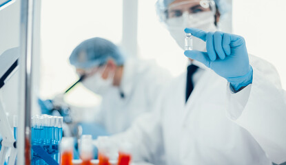 background image of a scientist recording test results in a lab log.