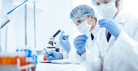close up. group of scientists testing the results of a new vaccine .