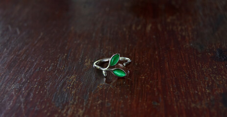 
White gold ring set with green gem