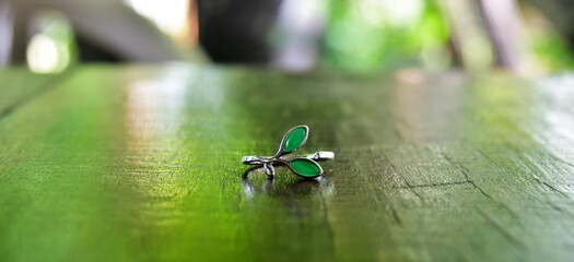 
White gold ring set with green gem