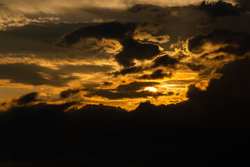 Beautiful sunset sky above clouds with dramatic light