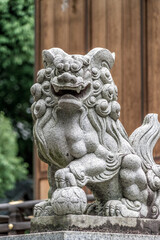 Fototapeta na wymiar Lion-dog guardian komainu (狛犬) at the entrance of a Shrine in Tokyo, Japan