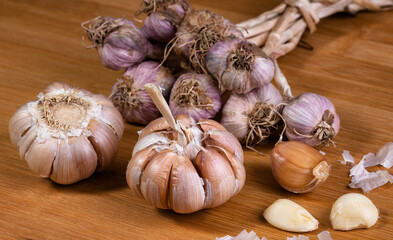 garlic bulb in wooden bowl place on background Concept of healthy food
