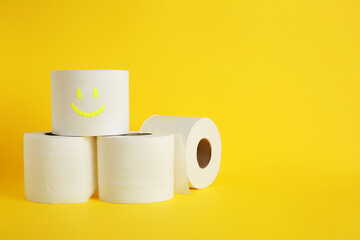 Rolls of toilet paper on color background
