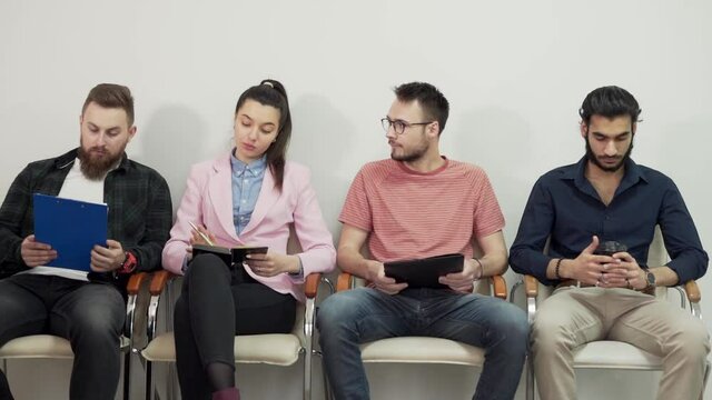 Sitting queue of young people for an interview