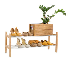 Stand with stylish shoes on white background