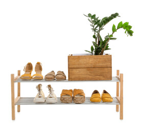 Stand with stylish shoes on white background