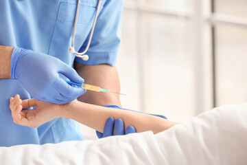 Female doctor working with patient in hospital room, closeup