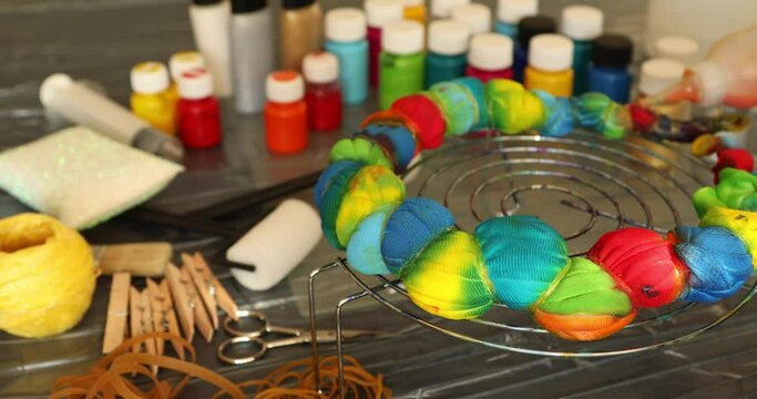 Woman applying tie dye technique to t shirt