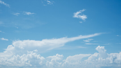 Large white clouds with clear blue sky background