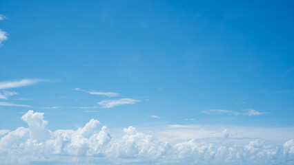 Large white clouds with clear blue sky background