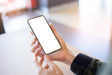 cell phone mockup image blank white screen.woman hand holding texting using mobile on desk at coffee shop.background empty space for advertise.work people contact marketing business,technology