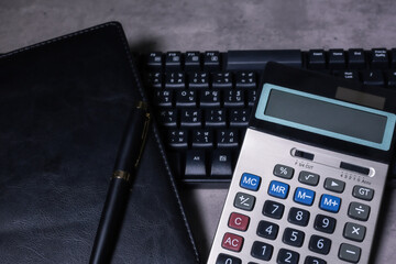 calculator and stationery items on the table for financial activity