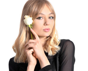 Beautiful young woman with rose on white background