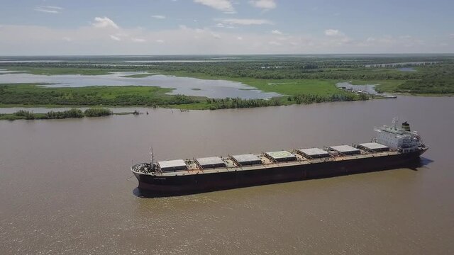 Cargo ship sailing on the parana river. Aerial View.