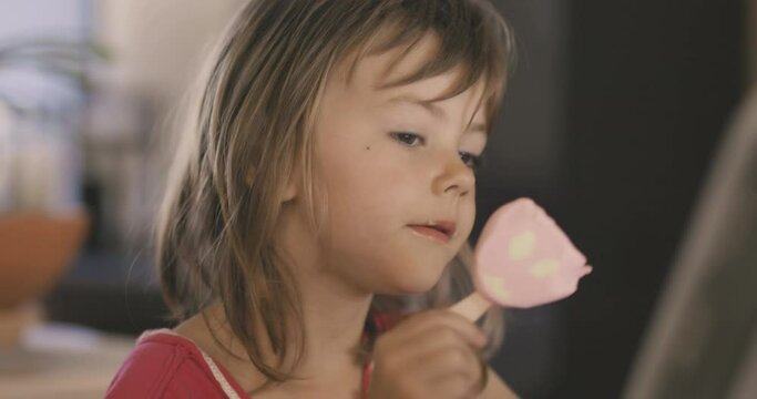 Adorable little girl licking ice cream