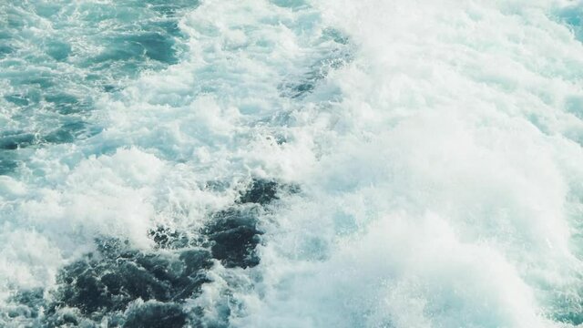 Slowmotion shot of wild backwash of a big ferry boat or cruise ship