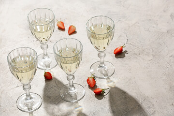 Glasses of tasty champagne and strawberry on table