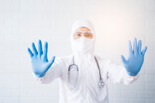 Medical healthcare scientist doctor making hand gesture warning stop sign wearing goggles blue latex gloves white lab suit stethoscope protective bacterial infection coronavirus, hospital laboratory