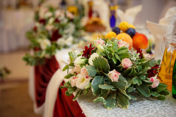 Decor of a wedding party. Wedding table decoration in a restaurant. Glasses, drinks, food. Festive decoration of the interior.