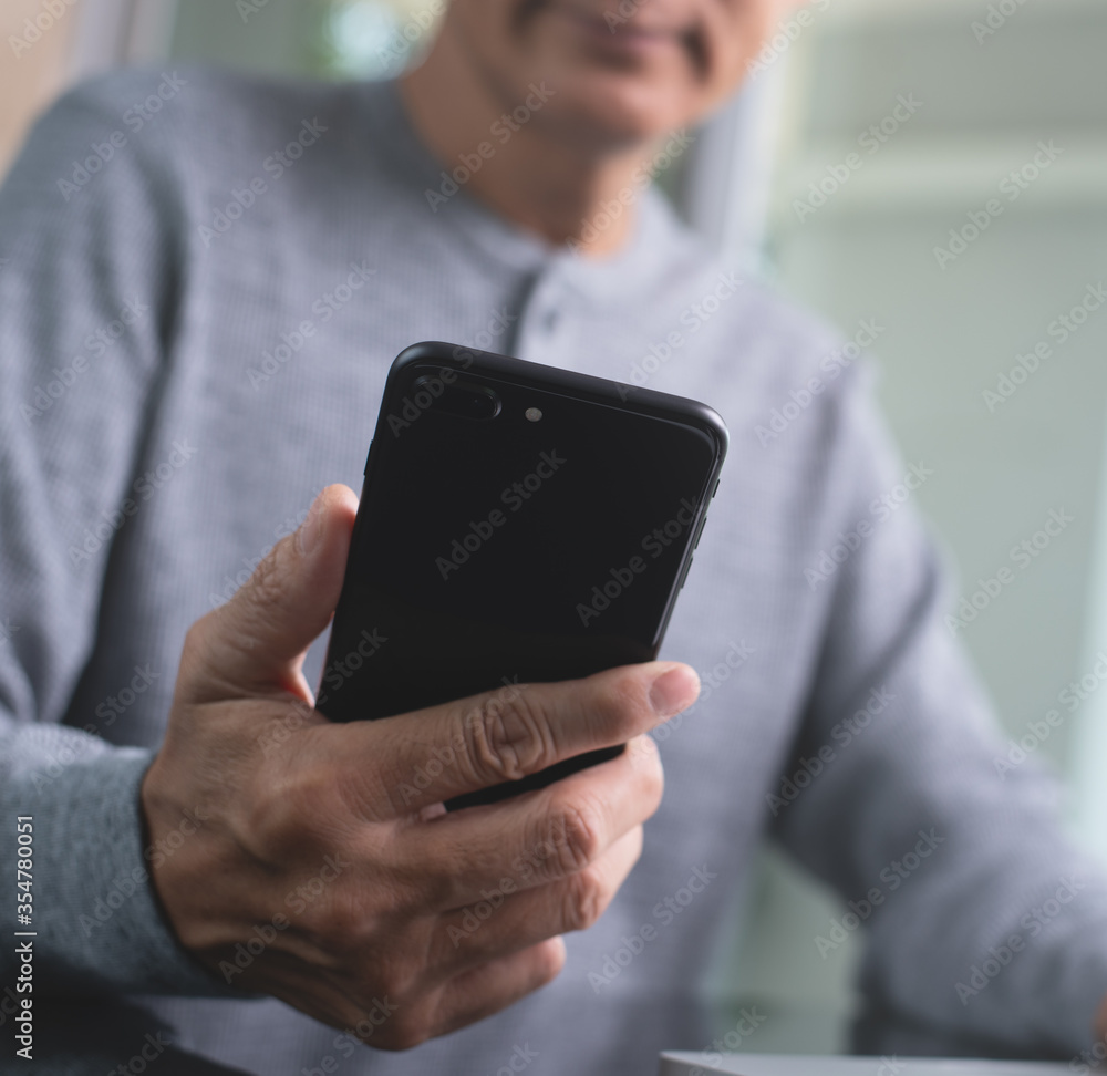 Poster casual man using mobile smart phone connecting internet at home