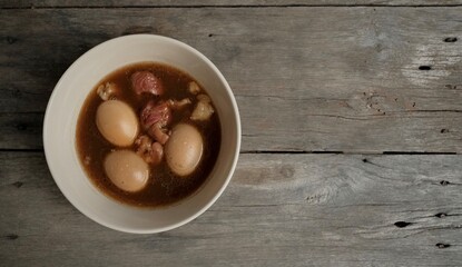 Stewed eggs in a bowl, placed on a wooden table.