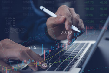 Business man anlyzing stock market report with financial graph 