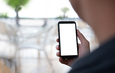 Mockup of man hand holding mobile phone in coffee shop or restaurant