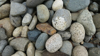 Fototapeta na wymiar stones on the beach background texture or wallpaper