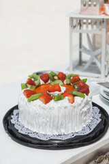 Wedding cake decorated for bride and groom to cut during tropical destination caribbean wedding marriage outdoor ceremony on the sandy beach in Dominican republic 
