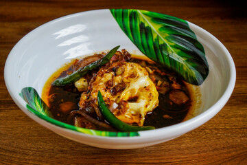 Fried eggs cooked in spicy soy sauce.