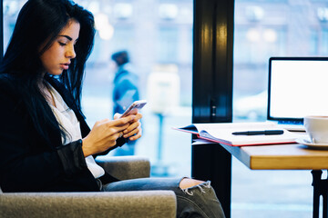 Smiling successful female entrepreneur checking email box receiving feedback with good news for...
