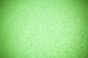 Rain droplets on green glass background, Water drops on green glass.