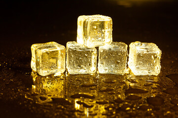 ice cubes on a reflections yellow light.