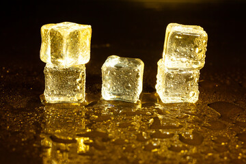 ice cubes on a reflections yellow light.