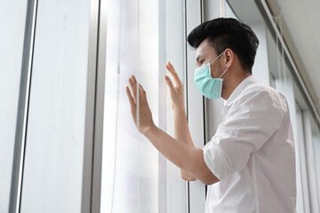 Fototapeta premium Patient man of coronavirus wear medical face mask during quarantine at home 