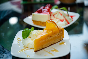 The layer of orange cake on white plate topping with honey.