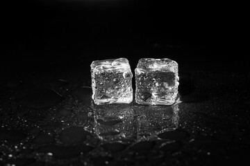 ice cubes on black table background.