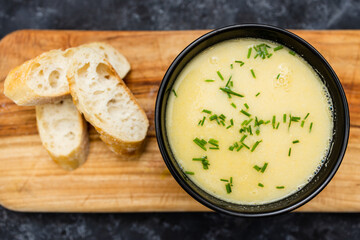 plant-based food, vegan corn cauliflower soup with chives topping and bread slices