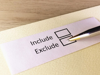 One person is answering question on a piece of paper. The person is thinking to include or to...