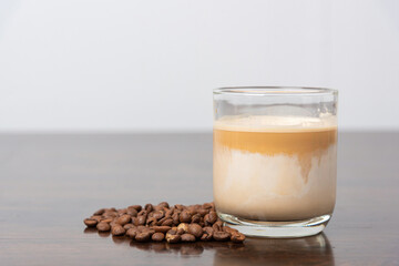 coffee latte with coffee bean on wooden table.