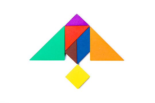 Color wood tangram puzzle in stingray or manta ray shape on white background