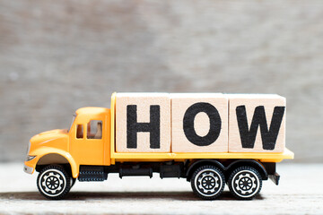 Truck hold letter block in word how on wood background