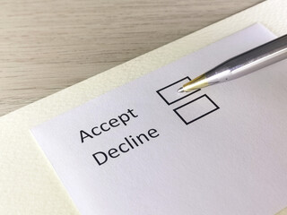 One person is answering question on a piece of paper. The person is thinking to accept or decline.