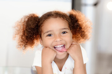 Young cute little girl gesturing with her mouth.