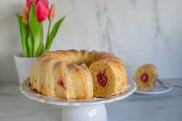 Home made sweet Raspberry Lemon Cake with tulips